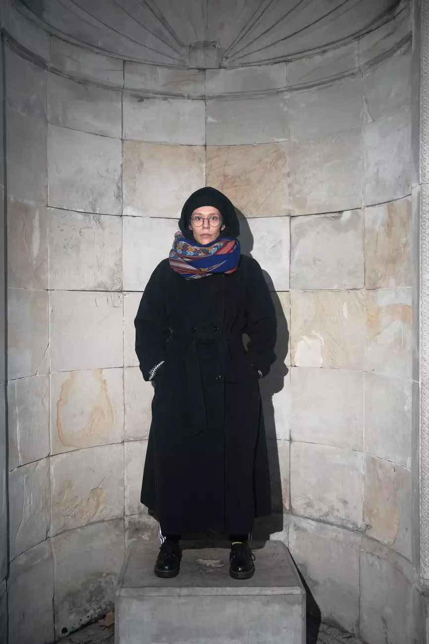 a portrait of teoniki rozynek in long coat