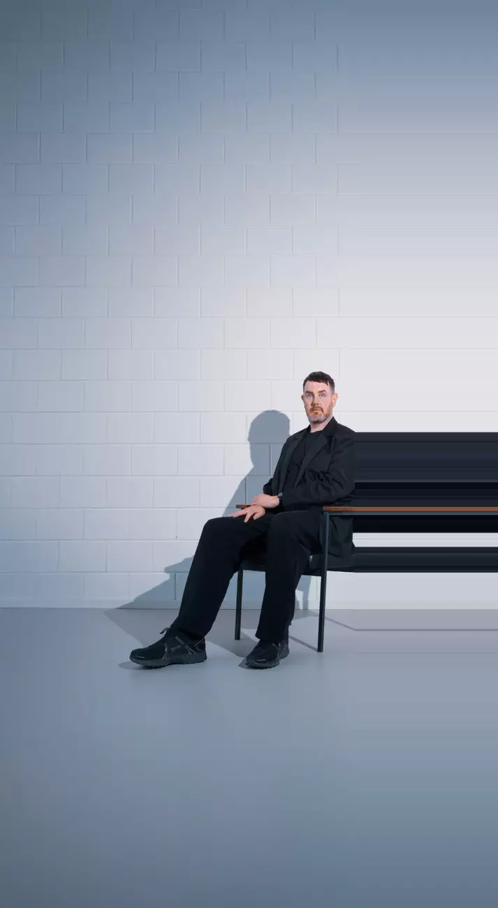 A man sitting by piano