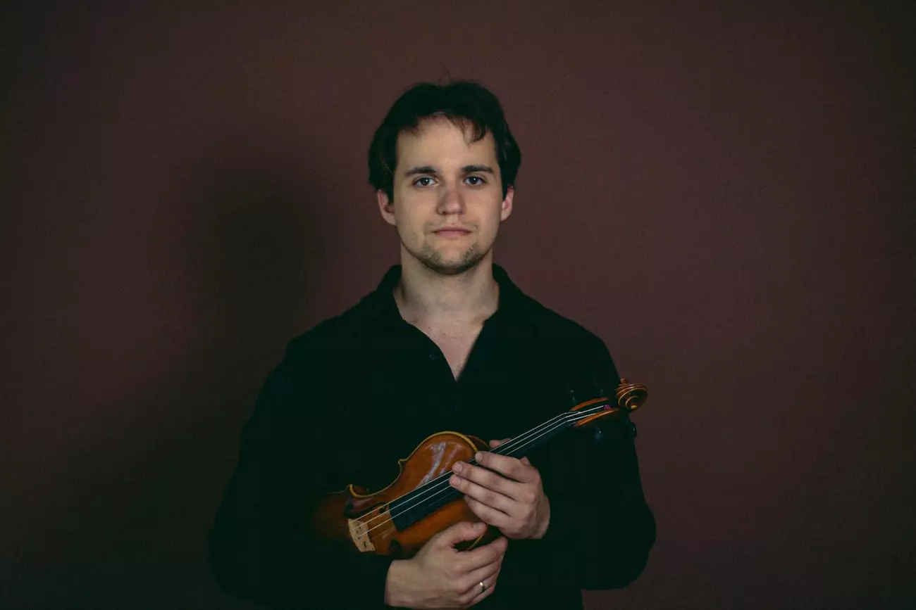 Akim Zvarych holding a violin