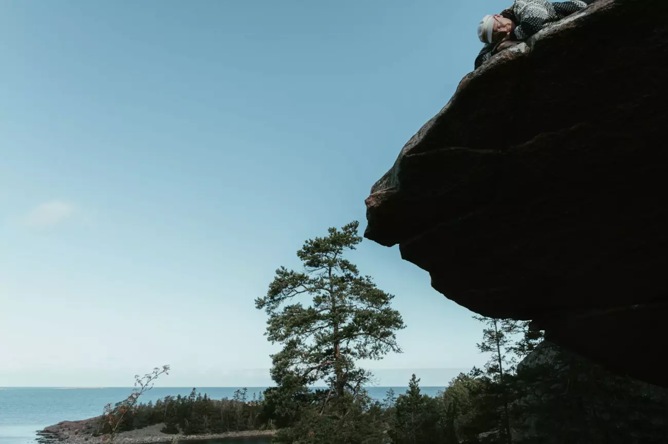 Lauri Supponen resting on a cliff