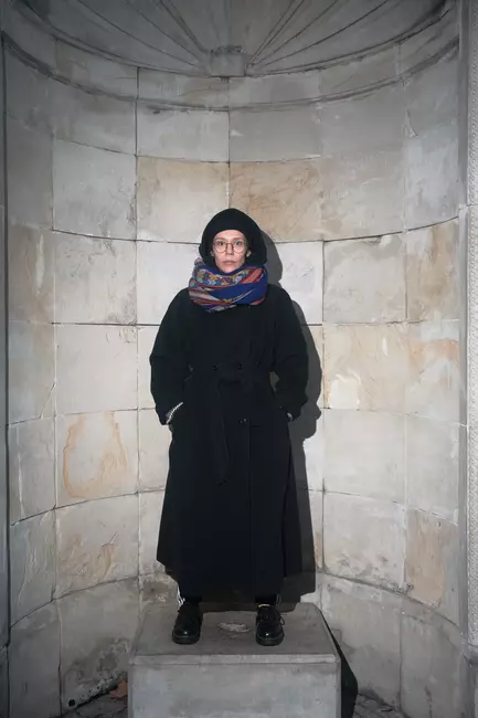 a portrait of teoniki rozynek in long coat