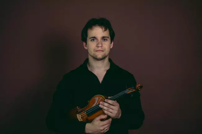 Akim Zvarych holding a violin