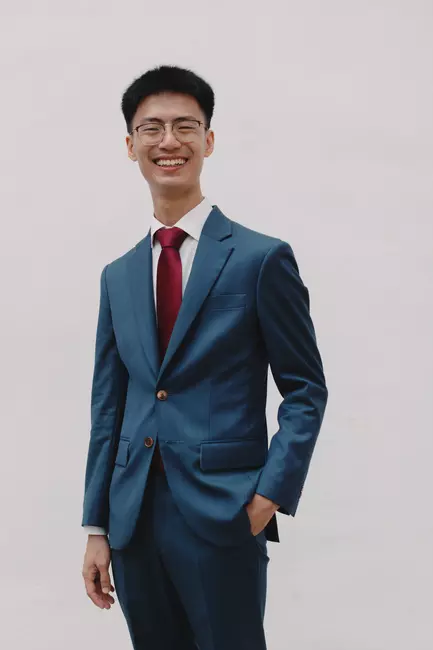 Photo of Tan Tiag Yi wearing a suit and tie