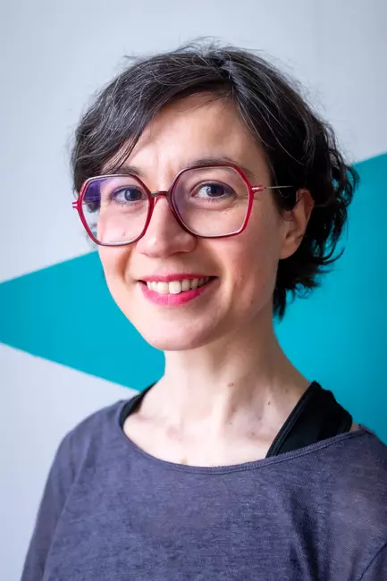 a smiling person looking at camera
