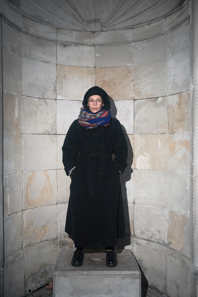 a portrait of teoniki rozynek in long coat